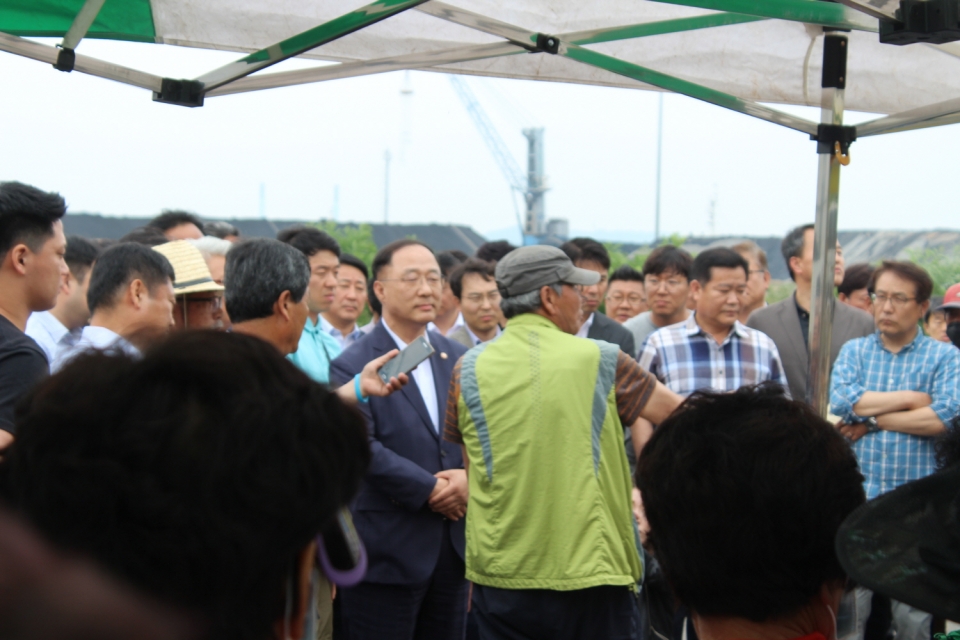 6월 19일 홍남기 국무조정실장에게  주민들이 항의하고 있다.