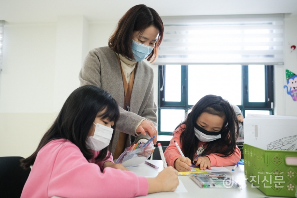 합덕공립지역아동센터에서 미술활동 중인 아이들과 (사진 가운데)이윤겸 센터장.